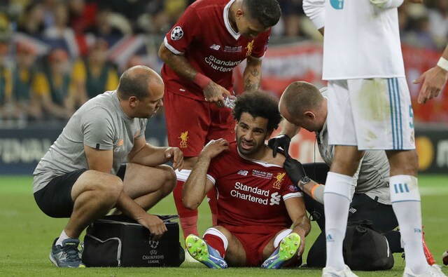 Liverpool's Mohamed Salah gets medical treatment after a collision with Real Madrid captain Sergio Ramos. AP Liverpool's Mohamed Salah gets medical treatment after a collision with Real Madrid captain Sergio Ramos. AP