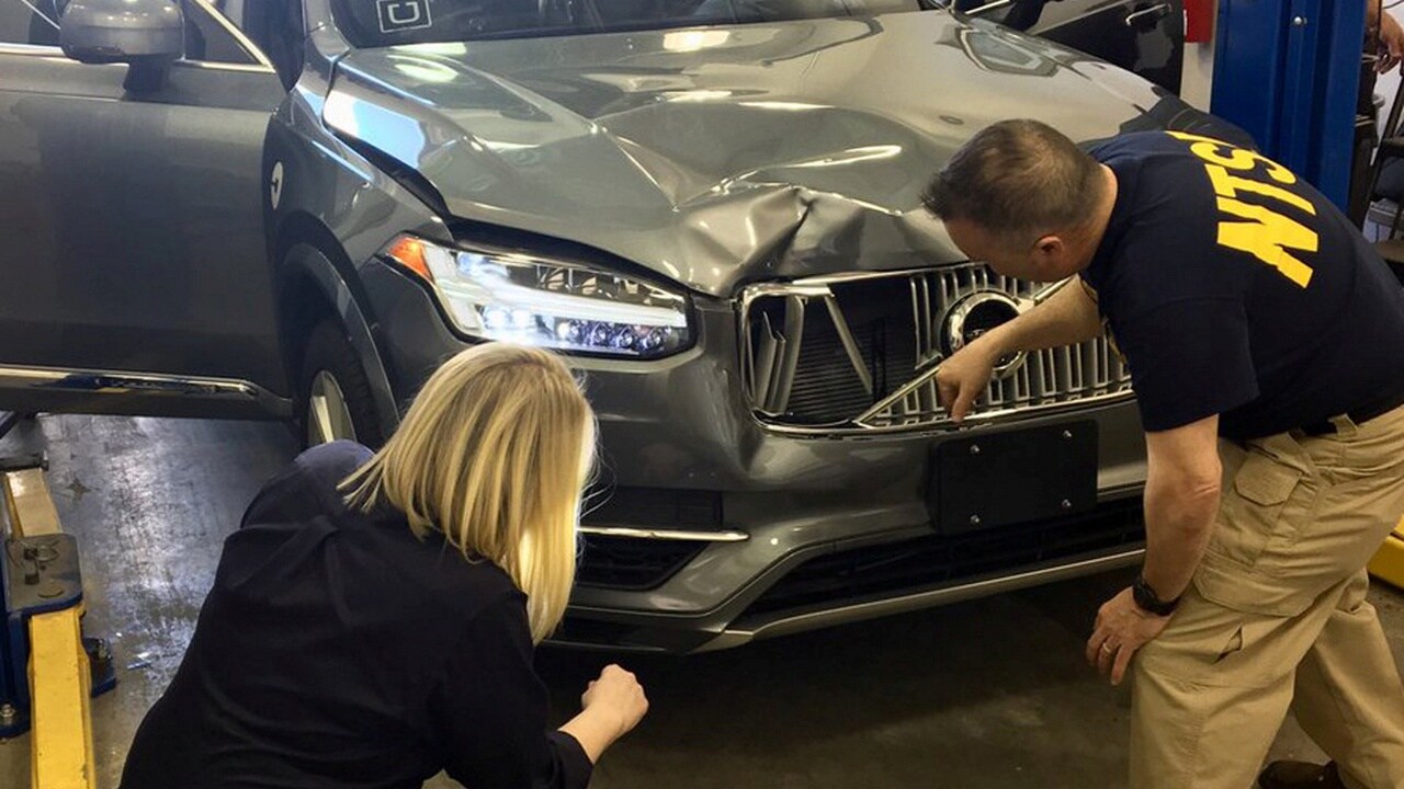 National Transportation Safety Board (NTSB) investigators examine a self-driving Uber vehicle involved in a fatal accident in Tempe, Arizona, U.S., March 20, 2018. A women was struck and killed by the vehicle on March 18, 2018. National Transportation Safety Board/Handout via REUTERS ATTENTION EDITORS - THIS IMAGE WAS PROVIDED BY A THIRD PARTY. - RC1D00CB6DF0