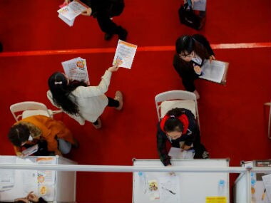 Students visit booths during a job fair at Donghua University in Shanghai, China November 20, 2014. . Reuters