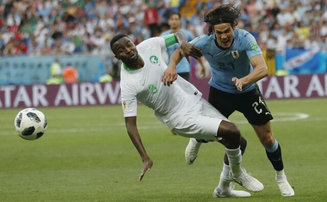 Uruguay's Edinson Cavani and Saudi Arabia's Osama Hawsawi fight for the ball. AP Uruguay's Edinson Cavani and Saudi Arabia's Osama Hawsawi fight for the ball. AP