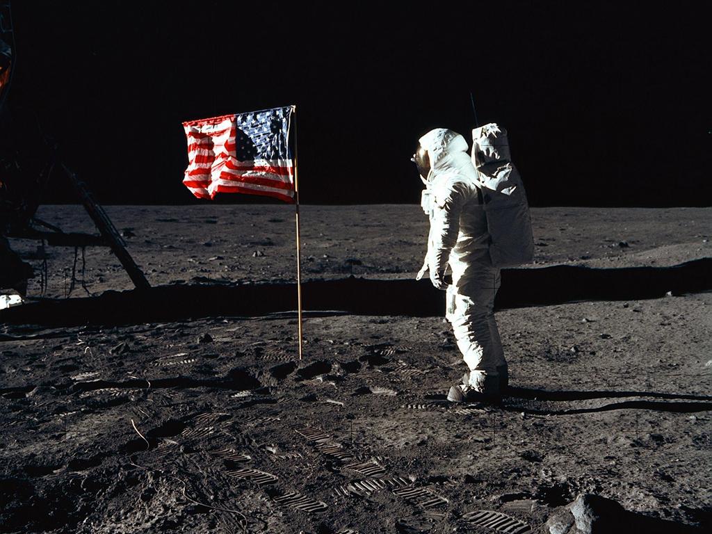 Astronaut Edwin E. Aldrin Jr., lunar module pilot of the first lunar landing mission, poses for a photograph beside the deployed US flag. Image: NASA