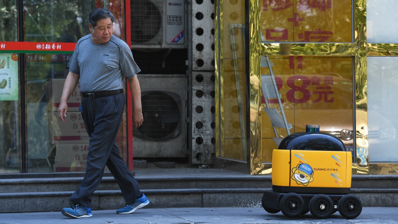 The delivery robot makes its way back to a supermarket during a demonstration in Beijing. AFP
