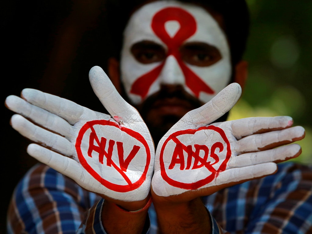 A student displays his hands painted with messages as he poses during an HIV/AIDS awareness campaign to mark the International AIDS Candlelight Memorial. Reuters.