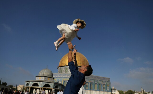 A man in Palestine plays with his child following morning prayers that mark the first day of Eid al-Adha celebrations, on the compound known to Muslims as al-Haram al-Sharif and to Jews as Temple Mount in Jerusalem's Old City on 21 August, 2018. Reuters/Ammar Awad A man in Palestine plays with his child following morning prayers that mark the first day of Eid al-Adha celebrations, on the compound known to Muslims as al-Haram al-Sharif and to Jews as Temple Mount in Jerusalem's Old City on 21 August, 2018. Reuters/Ammar Awad