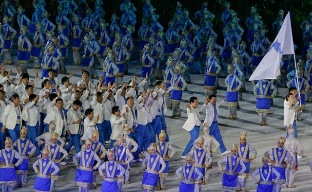 North Korea and South Korea put aside their differences to march under a unified banner. AP North Korea and South Korea put aside their differences to march under a unified banner. AP