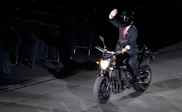 The Indonesian President Joko Widodo rides in on a motorcycle. AP The Indonesian President Joko Widodo rides in on a motorcycle. AP