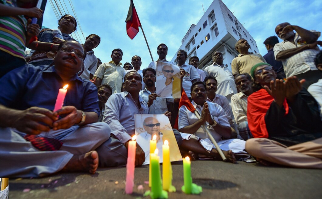 DMK supporters gather near the Kauvery Hospital, in Chennai on Tuesday. A massive controversy erupted on Tuesday after the Tamil Nadu government rejected Opposition DMK's demand for allotting space on the Marina beach for the burial of its leader M Karunanidhi. The cadres held impromptu protests and engaged in sloganeering demanding a place for Karunanidhi's burial at the Marina Beach even as minor incidents of violence were reported from some parts of the state. PTI DMK supporters gather near the Kauvery Hospital, in Chennai on Tuesday. A massive controversy erupted on Tuesday after the Tamil Nadu government rejected Opposition DMK's demand for allotting space on the Marina beach for the burial of its leader M Karunanidhi. The cadres held impromptu protests and engaged in sloganeering demanding a place for Karunanidhi's burial at the Marina Beach even as minor incidents of violence were reported from some parts of the state. PTI