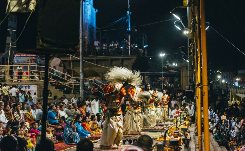 The evening ceremony at the ghats reaches its fever pitch with the final aarti. People swaying. Their faces lit golden in the light of the flames. The fire rising to the sky, reflecting into the cold, dark water below. The evening ceremony at the ghats reaches its fever pitch with the final aarti. People swaying. Their faces lit golden in the light of the flames. The fire rising to the sky, reflecting into the cold, dark water below.