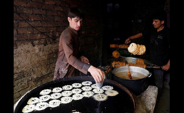 Afghan men make sweets at a small traditional factory ahead of Eid al-Adha, also known as Bakri Eid, in Kabul, Afghanistan on 19 August 2018. Reuters/ Mohammad Ismail Afghan men make sweets at a small traditional factory ahead of Eid al-Adha, also known as Bakri Eid, in Kabul, Afghanistan on 19 August 2018. Reuters/ Mohammad Ismail
