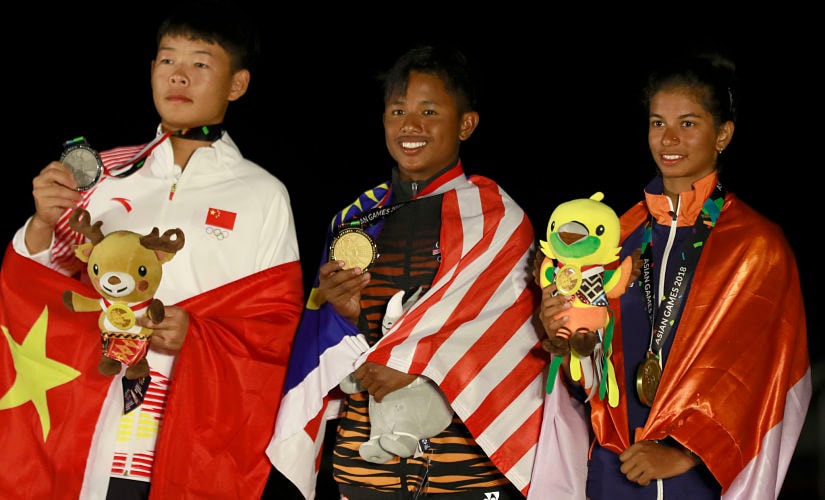 From left to right silver medalist Wang Jianxiong of China ,gold medalist Kaman Shah Muhammad Fauzi of Malaysia and bronze medalist Thomas Harshita of India with their medals during the victory ceremony for in the Open Laser 4,7 of sailing event at the18th Asian Games in Jakarta, Indonesia, Friday, Aug. 31, 2018.(AP Photo/Tatan Syuflana)