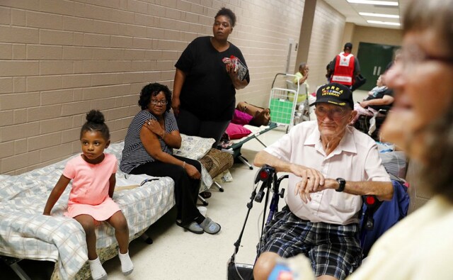 Korea war veteran, Ed Coddington, 83, second from right, and wife Esther, 78, wait with Markia McCleod, rear, her aunt Ernestine McCleod and daughter Keymoni, 4, in a shelter for Hurricane Florence to pass after evacuating from their nearby homes. AP Korea war veteran, Ed Coddington, 83, second from right, and wife Esther, 78, wait with Markia McCleod, rear, her aunt Ernestine McCleod and daughter Keymoni, 4, in a shelter for Hurricane Florence to pass after evacuating from their nearby homes. AP