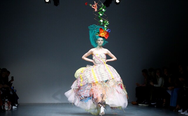 Another creation by the York-born designer Matty Bovan presented on the first day of the London Fashion Week 2018 that flagged off on Friday, 14 September and will close on Tuesday, 18 September. His collection consisted of a multitude of pieces of cloth coupled with bright colours and bold finishes. Reuters/Henry Nicholls Another creation by the York-born designer Matty Bovan presented on the first day of the London Fashion Week 2018 that flagged off on Friday, 14 September and will close on Tuesday, 18 September. His collection consisted of a multitude of pieces of cloth coupled with bright colours and bold finishes. Reuters/Henry Nicholls