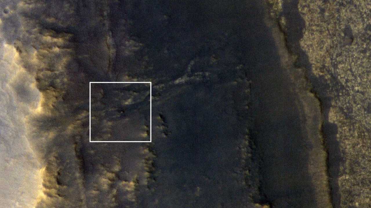 NASA's Opportunity rover appears as a blip in the center of the image taken by a high-resolution camera on the Mars Orbiter after the dust storm had substantially cleared. Image courtesy NASA/JPL