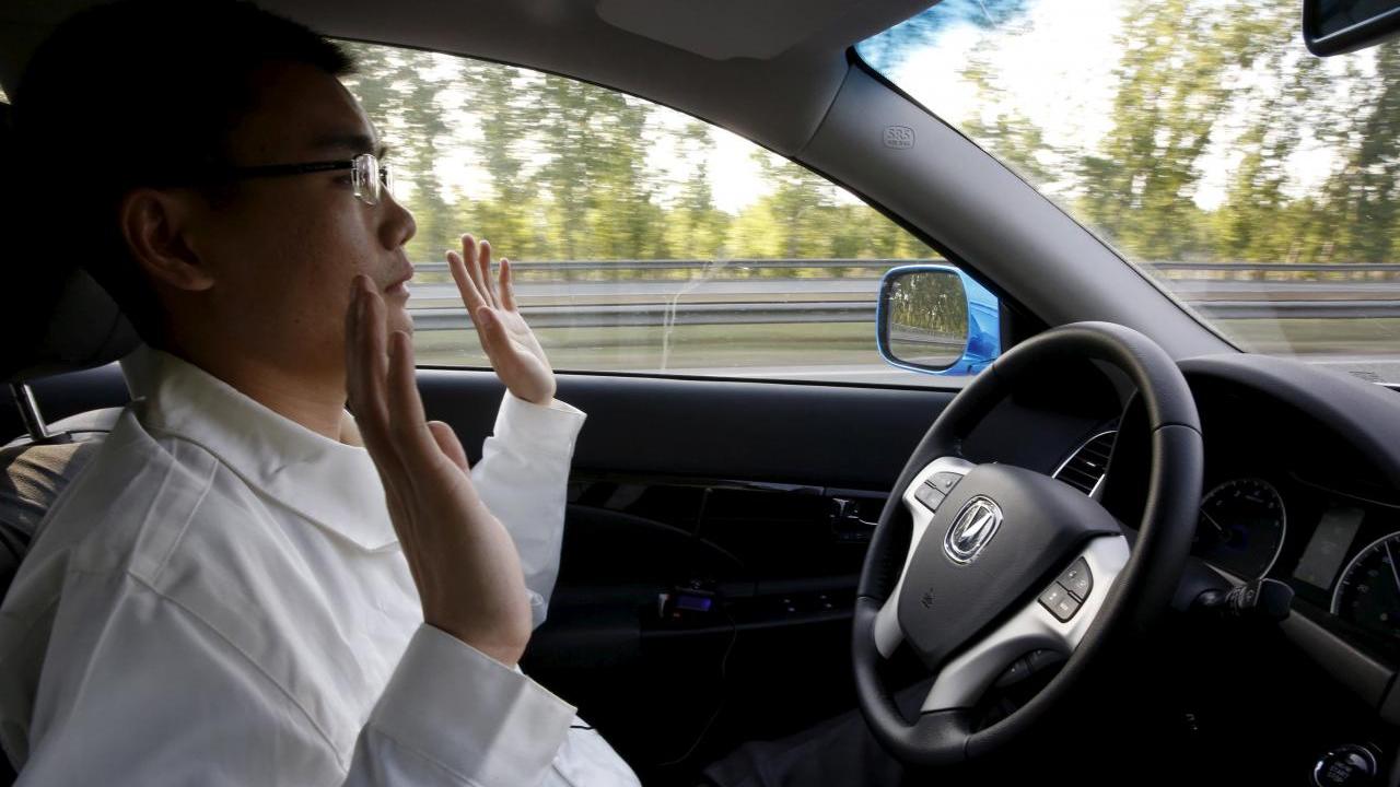A development engineer at Changan Automobile, lifts his hands off the steering wheel as the car is on self-driving mode during a test drive on a highway in Beijing, China, April 16, 2016. Image: Reuters