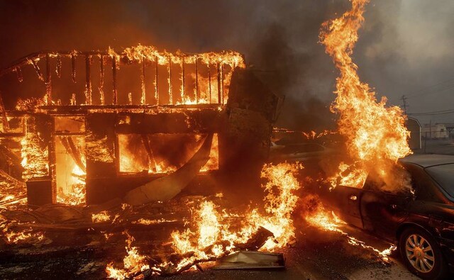 Flames consumed cars and buildings as the wildfire tore through Paradise in California. AP Flames consumed cars and buildings as the wildfire tore through Paradise in California. AP