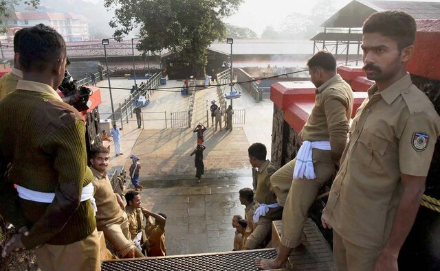 Police personnel stood on guard at the 18 sacred steps of the Lord Ayyappa temple on the 2nd day of Malayalam month of 'Vrischikom.' The Sabarimala temple opened its doors at 5 pm on 17 November for two months. Police personnel stood on guard at the 18 sacred steps of the Lord Ayyappa temple on the 2nd day of Malayalam month of 'Vrischikom.' The Sabarimala temple opened its doors at 5 pm on 17 November for two months.
