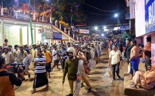 Police personnel detained the devotees who were staging 'Namajapa' protest against the police restrictions at Sannidhanam, in Sabarimala. PTI Police personnel detained the devotees who were staging 'Namajapa' protest against the police restrictions at Sannidhanam, in Sabarimala. PTI