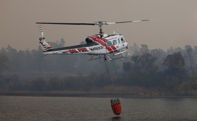 Cal Fire helicopter were deployed to pick up water from a reservoir to battle the wildfires. Reuters Cal Fire helicopter were deployed to pick up water from a reservoir to battle the wildfires. Reuters
