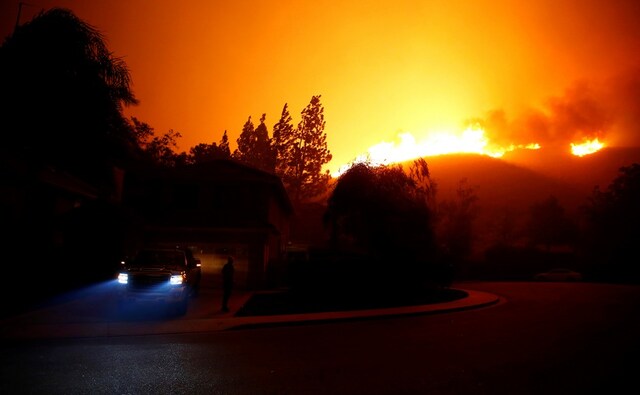 Flames approached residential areas as firefighters battled the blaze overnight during a wildfire that burned dozens of homes at Thousand Oaks in California. Reuters Flames approached residential areas as firefighters battled the blaze overnight during a wildfire that burned dozens of homes at Thousand Oaks in California. Reuters