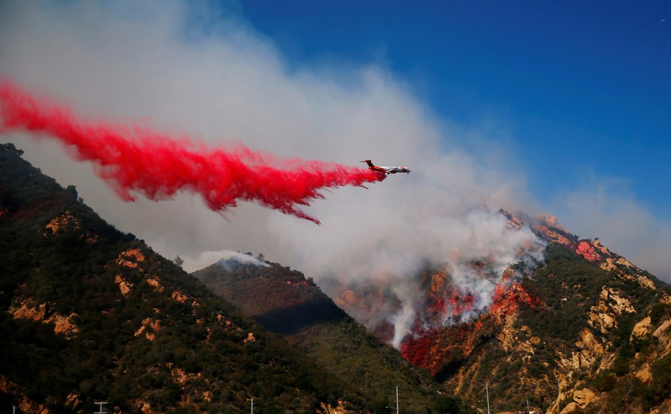 Aircraft were deployed to drop flame retardant as firefighters battled the wildfire on ground. Reuters Aircraft were deployed to drop flame retardant as firefighters battled the wildfire on ground. Reuters
