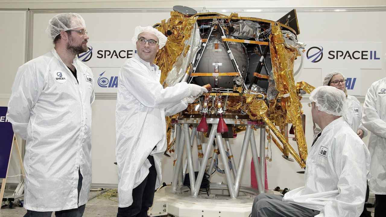 Yariv Bash (right), Yonatan Winetraub (middle) and Kfir Damari (left), founders of SpaceIL, insert a time capsule into the Genesis spacecraft on 17 December. Image credit: Yoav Weiss