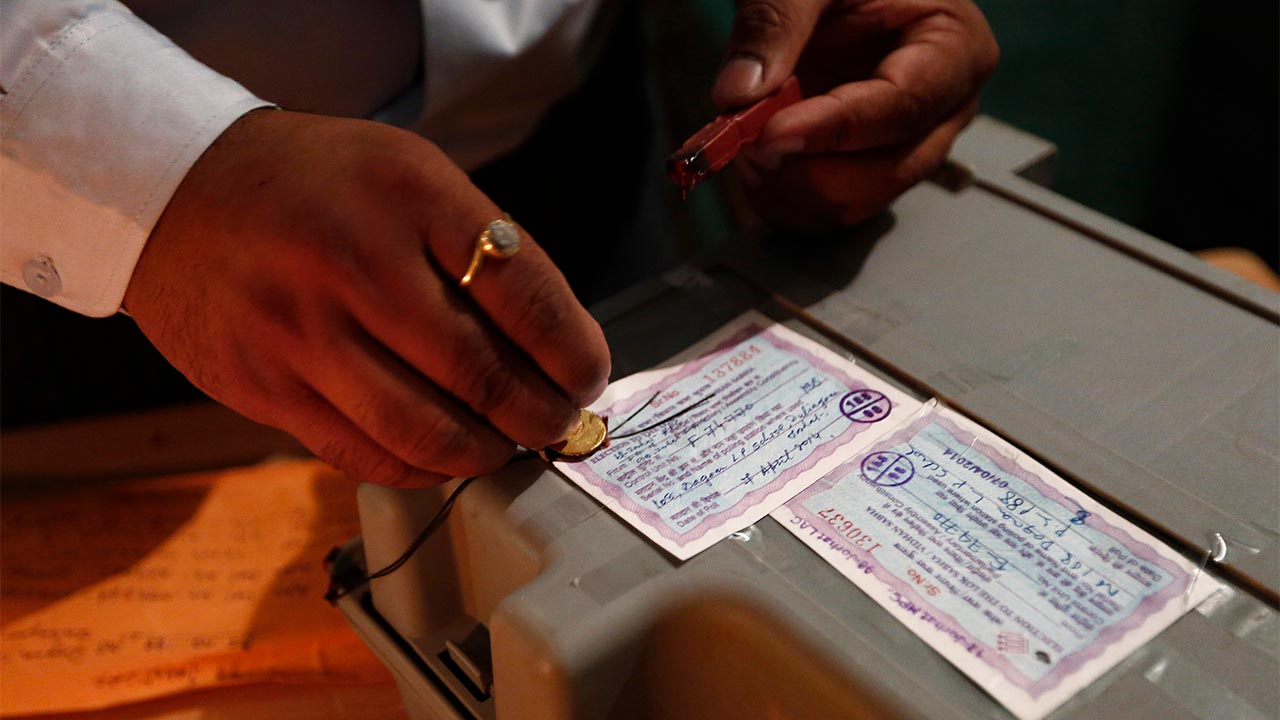 A polling official seals an EVM. Image: Reuters
