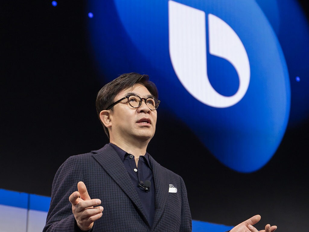 HS Kim, President and CEO of Samsung Consumer Electronics Division against a background with the Bixby symbol. Image: Reuters