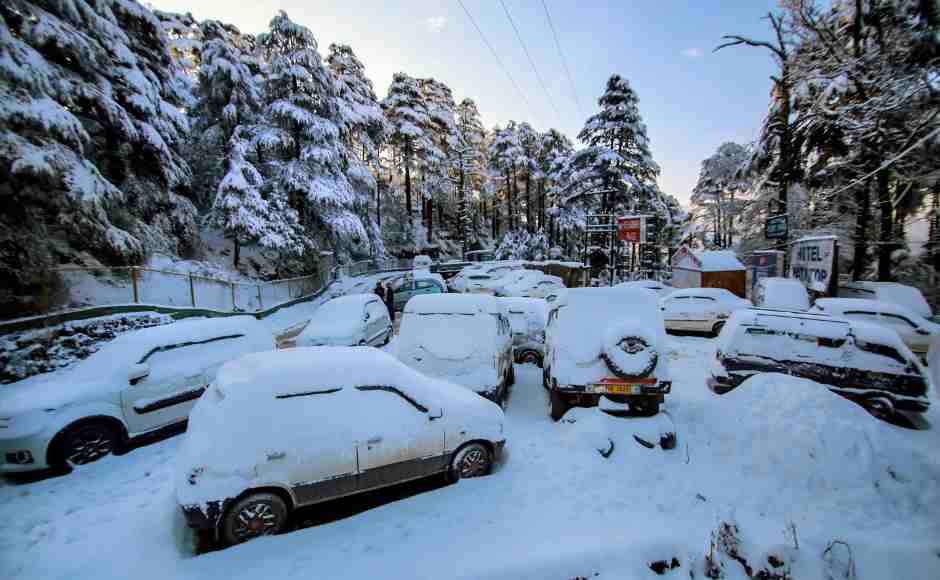 Snow-covered vehicles parked near the Jammu-Srinagar national highway. PTI Snow-covered vehicles parked near the Jammu-Srinagar national highway. PTI