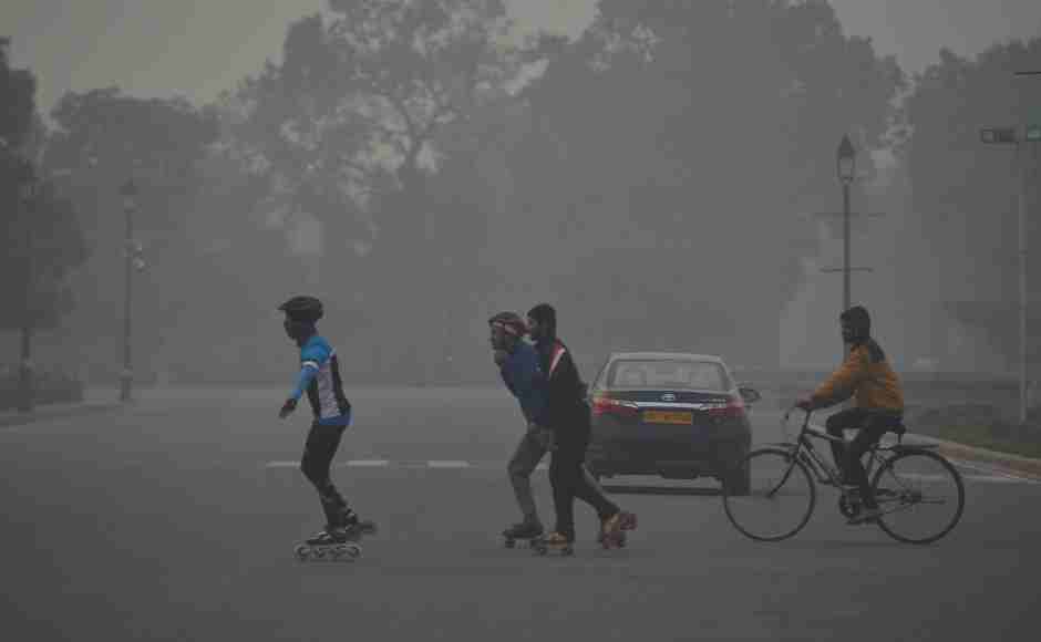 Skaters cross a road near Raisina Hills in New Delhi on a cold, foggy morning. PTI Skaters cross a road near Raisina Hills in New Delhi on a cold, foggy morning. PTI
