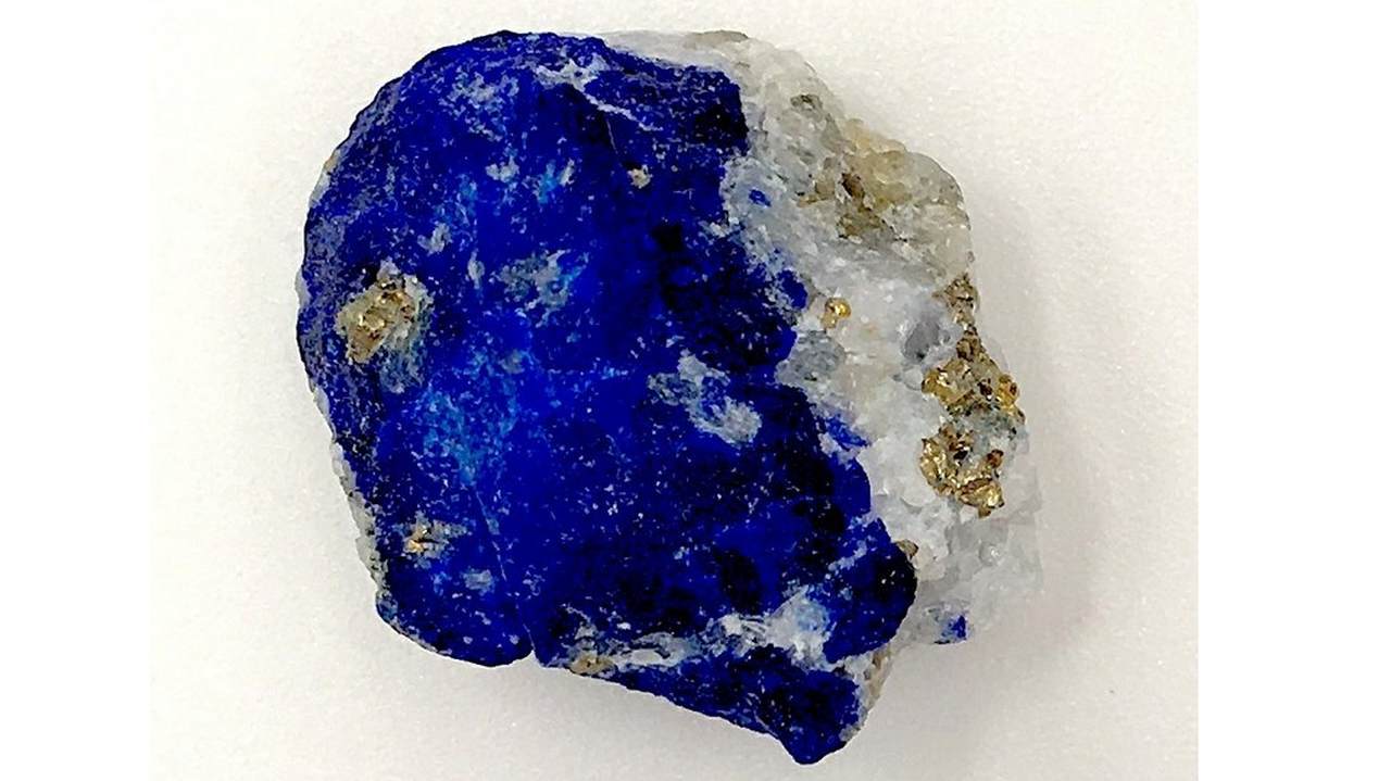 This undated photo released by the Max Planck Institute for the Science of Human History in Jena, Germany, shows a piece of lapis lazuli. During the European Middle Ages, Afghanistan was the only known source of the rare blue stone which at the time was ground up and used as a pigment. Modern-day scientists who examined the 1,000 year-old remains of a middle-aged woman in Germany discovered the semi-precious stone in the tartar on her teeth. From that, they concluded the woman was an artist involved in creating illuminated manuscripts, a task usually associated with monks. The find is considered the most direct evidence yet of a woman taking part in the making of high-quality illuminated manuscripts, the lavishly illustrated religious and secular texts of the Middle Ages. And it corroborates other findings that suggest female artisans were not as rare as previously thought. (Christina Warinner/Max Planck Institute for the Science of Human History via AP)