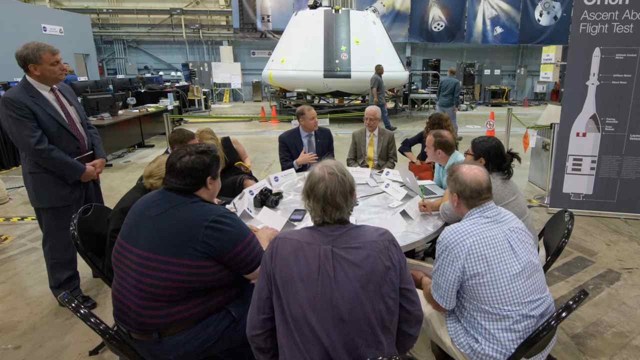 Jim Bridenstine (left, facing camera), and NASA Johnson Space Center Director Mark Geyer (right, facing camera), participate in a media roundtable in front of the Orion test crew capsule at NASA's Johnson Space Center in Houston. Image credit: NASA