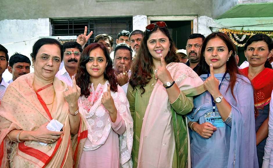 Maharashtra Women and Child Welfare Minister Pankaja Munde, BJP candidate Pritam Munde and others voters show their fingers marked with indelible ink at a polling booth in Maharashtra's Beed. The state registered a turnout of 57.87 percent. PTI Maharashtra Women and Child Welfare Minister Pankaja Munde, BJP candidate Pritam Munde and others voters show their fingers marked with indelible ink at a polling booth in Maharashtra's Beed. The state registered a turnout of 57.87 percent. PTI