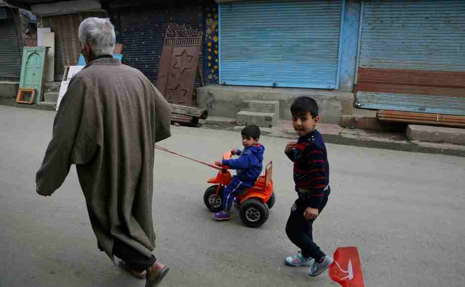 An elderly Kashmiri man pulls a child on a tricycle during a strike called on the second phase of elections in Srinagar. AP An elderly Kashmiri man pulls a child on a tricycle during a strike called on the second phase of elections in Srinagar. AP