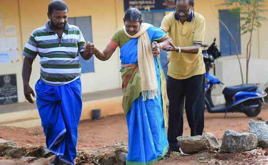 An elderly voter is assisted as she arrives to cast vote at a polling station in Nagercoil in Kanyakumari. PTI An elderly voter is assisted as she arrives to cast vote at a polling station in Nagercoil in Kanyakumari. PTI