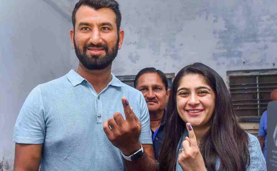 Indian cricketer Cheteshwer Pujara and his wife Puja Pabari show their inked marked fingers at a polling station in Rajkot. PTI Indian cricketer Cheteshwer Pujara and his wife Puja Pabari show their inked marked fingers at a polling station in Rajkot. PTI