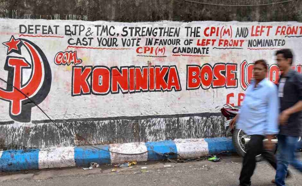Pedestrians walk past a wall graffiti painted in support of the Left Party ahead of Lok Sabha polls in Kolkata. PTI Pedestrians walk past a wall graffiti painted in support of the Left Party ahead of Lok Sabha polls in Kolkata. PTI