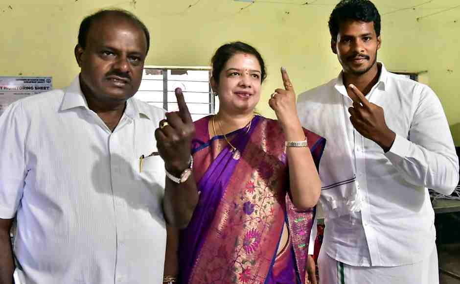 Karnataka chief minister HD Kumaraswamy along with wife Anitha Kumaraswamy (C) and son Nikhil Gowda (R) show their finger marked with indelible ink after casting vote at a polling station at Kethiganahalli in Ramanagara district. PTI Karnataka chief minister HD Kumaraswamy along with wife Anitha Kumaraswamy (C) and son Nikhil Gowda (R) show their finger marked with indelible ink after casting vote at a polling station at Kethiganahalli in Ramanagara district. PTI