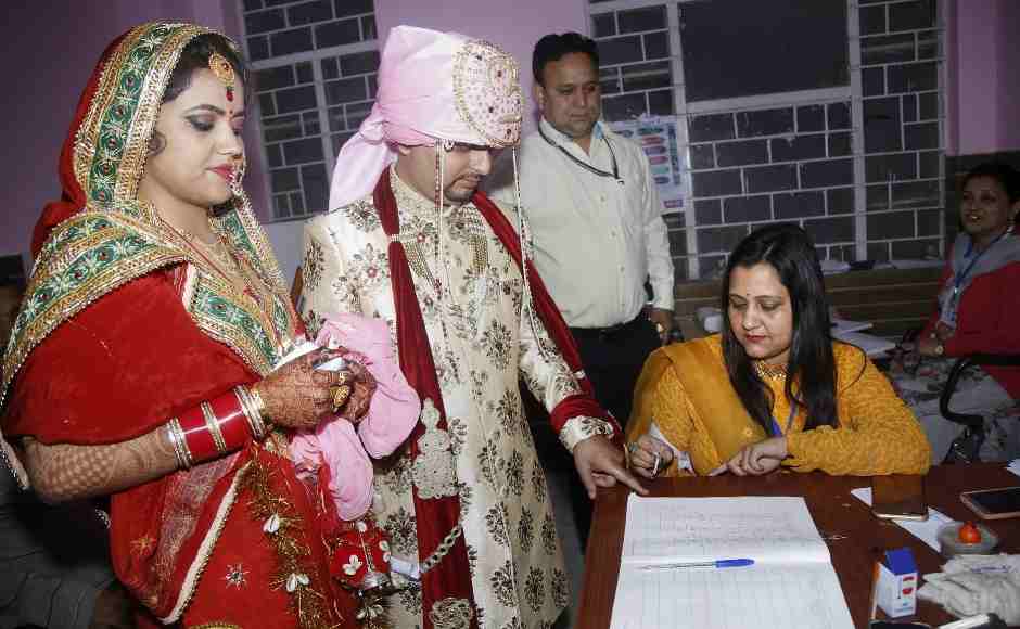 A polling officer puts an indelible ink mark on the finger of a newly married couple at a polling station in Udhampur district of Jammu and Kashmir. PTI A polling officer puts an indelible ink mark on the finger of a newly married couple at a polling station in Udhampur district of Jammu and Kashmir. PTI
