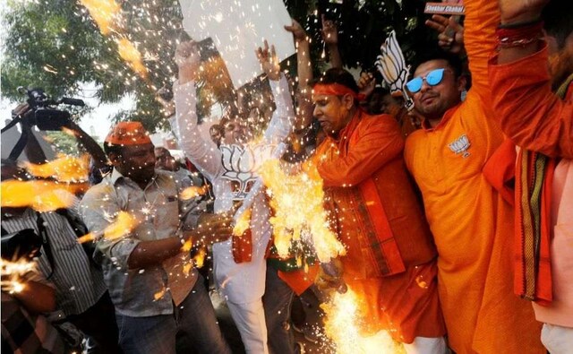 BJP supporters celebrated after learning the initial election results outside the party headquarters in New Delhi, India. Reuters. BJP supporters celebrated after learning the initial election results outside the party headquarters in New Delhi, India. Reuters.
