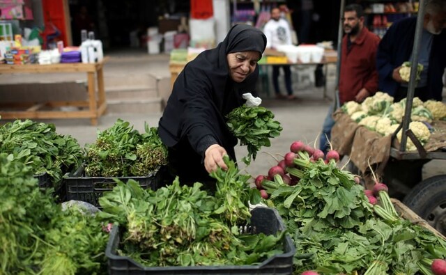 A Palestinian woman sells vegetables on the first day of Ramadan, in the southern Gaza Strip. Reuters/Ibraheem Abu Mustafa. A Palestinian woman sells vegetables on the first day of Ramadan, in the southern Gaza Strip. Reuters/Ibraheem Abu Mustafa.