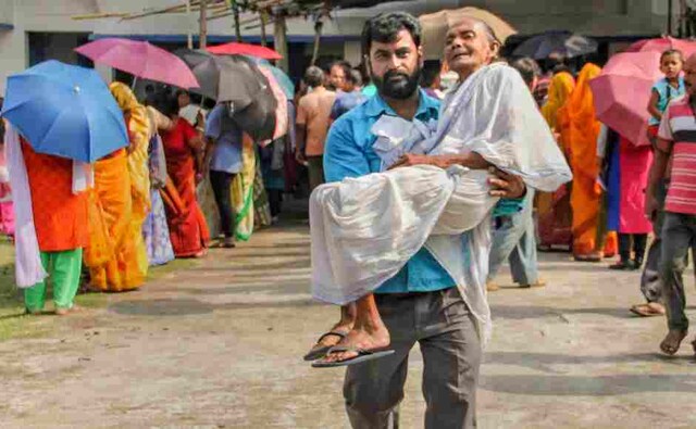 An elderly woman was carried by a relative near a polling station in Bangaon parliamentary constituency during the fifth phase of Lok Sabha elections in Nadia district on Monday. PTI An elderly woman was carried by a relative near a polling station in Bangaon parliamentary constituency during the fifth phase of Lok Sabha elections in Nadia district on Monday. PTI