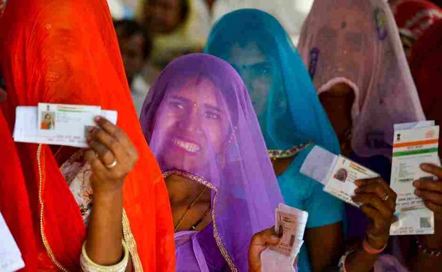 Women in Nagaur district showed their ID cards as they waited to cast their votes at a polling station. PTI Women in Nagaur district showed their ID cards as they waited to cast their votes at a polling station. PTI