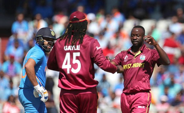 West Indies' Kemar Roach celebrates after dismissing Rohit Sharma. The right-handed batsman departed early to put India at 29-1. AP West Indies' Kemar Roach celebrates after dismissing Rohit Sharma. The right-handed batsman departed early to put India at 29-1. AP