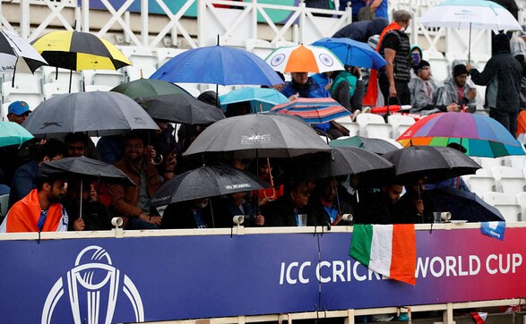Fans with umbrellas wait patiently for the match resumption, but were well-prepared for the heavy rain. Reuters Fans with umbrellas wait patiently for the match resumption, but were well-prepared for the heavy rain. Reuters