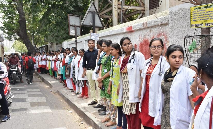 Doctors at several hospitals registered their protest by wearing bandages on their foreheads, black arm-bands and some even put on helmets as a sign of protest. The IMA had launched a four-day nationwide protest from Friday over the Kolkata incident and wrote to Union Home Minister Amit Shah demanding enactment of a central law to check violence against healthcare workers. Image courtesy: Mydeen Abdul Kathar/101Reporters Doctors at several hospitals registered their protest by wearing bandages on their foreheads, black arm-bands and some even put on helmets as a sign of protest. The IMA had launched a four-day nationwide protest from Friday over the Kolkata incident and wrote to Union Home Minister Amit Shah demanding enactment of a central law to check violence against healthcare workers. Image courtesy: Mydeen Abdul Kathar/101Reporters