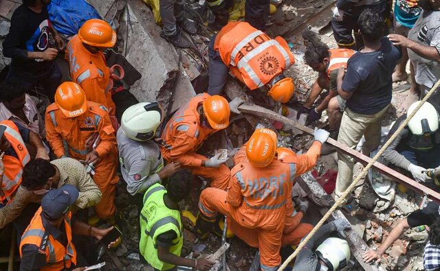 Ten persons were killed after a four-storey residential building collapsed in south Mumbai's congested Dongri area on Tuesday, trapping over 40 people under the debris, civic officials said. Fire Brigade and NDRF personnel began rescue work after the collapse. PTI Ten persons were killed after a four-storey residential building collapsed in south Mumbai's congested Dongri area on Tuesday, trapping over 40 people under the debris, civic officials said. Fire Brigade and NDRF personnel began rescue work after the collapse. PTI