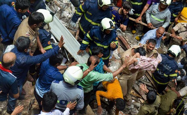 Nine persons were injured after the Kesarbai building, located in a bustling lane off Tandel Street, crashed, a civic official said. Visuals of a child being pulled out of the debris was shown across television channels. An official later said that the child was pulled out of the rubble alive. PTI Nine persons were injured after the Kesarbai building, located in a bustling lane off Tandel Street, crashed, a civic official said. Visuals of a child being pulled out of the debris was shown across television channels. An official later said that the child was pulled out of the rubble alive. PTI