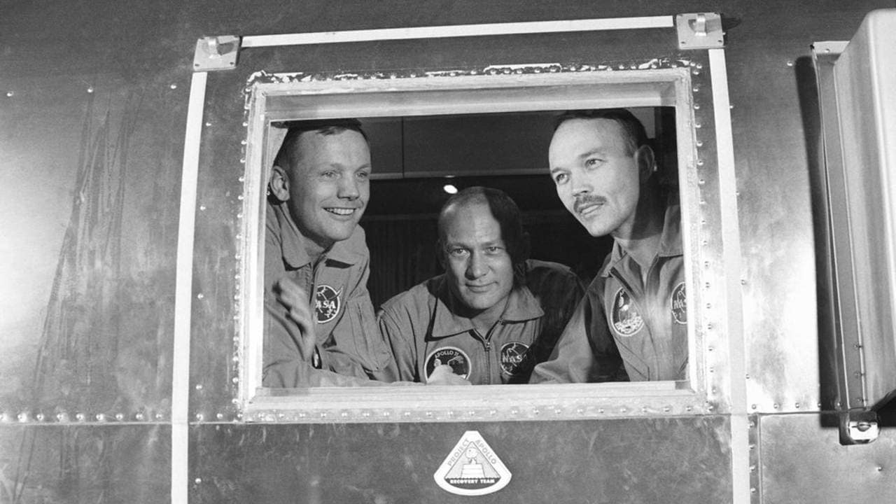 Apollo 11 crew members, from left, Neil Armstrong, Buzz Aldrin and Michael Collins sit inside a quarantine van in Houston. Image: AP.