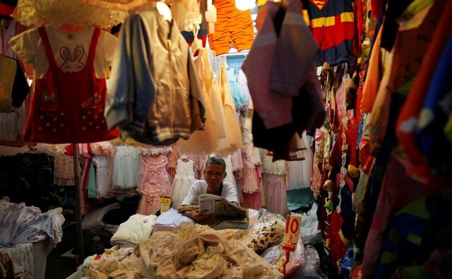 A vendor in a local market awaits his customers as normal life in Hong Kong continues to be coloured by the strains of protests against the extradition bill. Reuters/ Willy Kurniawan A vendor in a local market awaits his customers as normal life in Hong Kong continues to be coloured by the strains of protests against the extradition bill. Reuters/ Willy Kurniawan