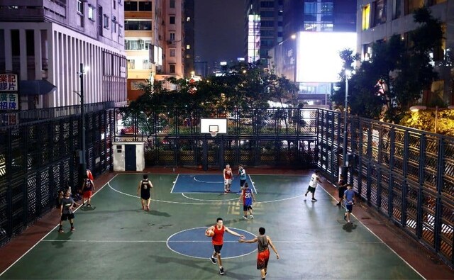 People play basketball on an inner-city playground in the Wan Chai neighbourhood in Hong Kong. Reuters/ Thomas Peter People play basketball on an inner-city playground in the Wan Chai neighbourhood in Hong Kong. Reuters/ Thomas Peter